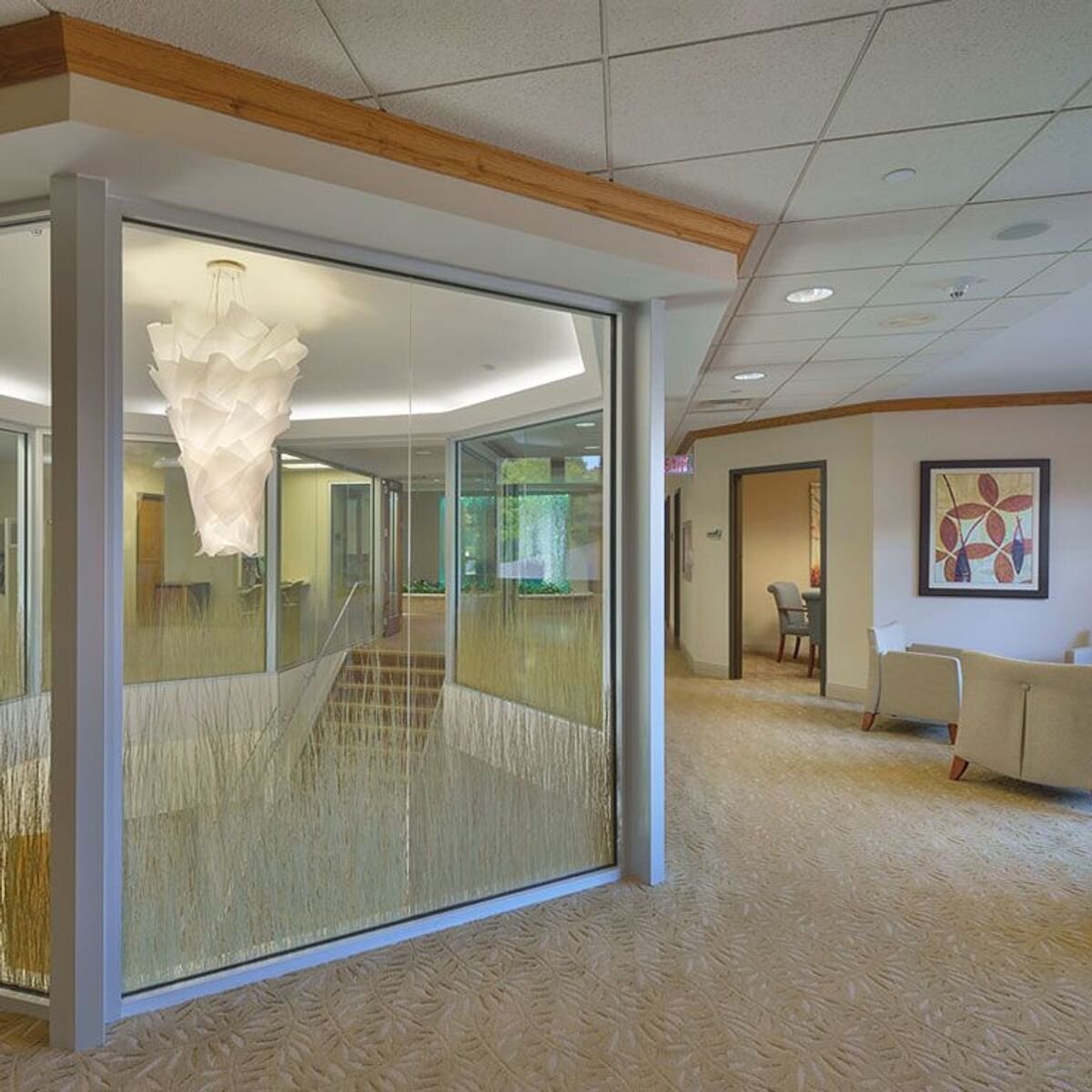 stairwell surrounded by glass with hanging light fixture