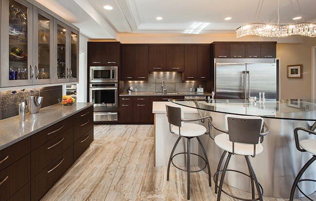 Kitchen with dark brown cabinets and glass bar seating